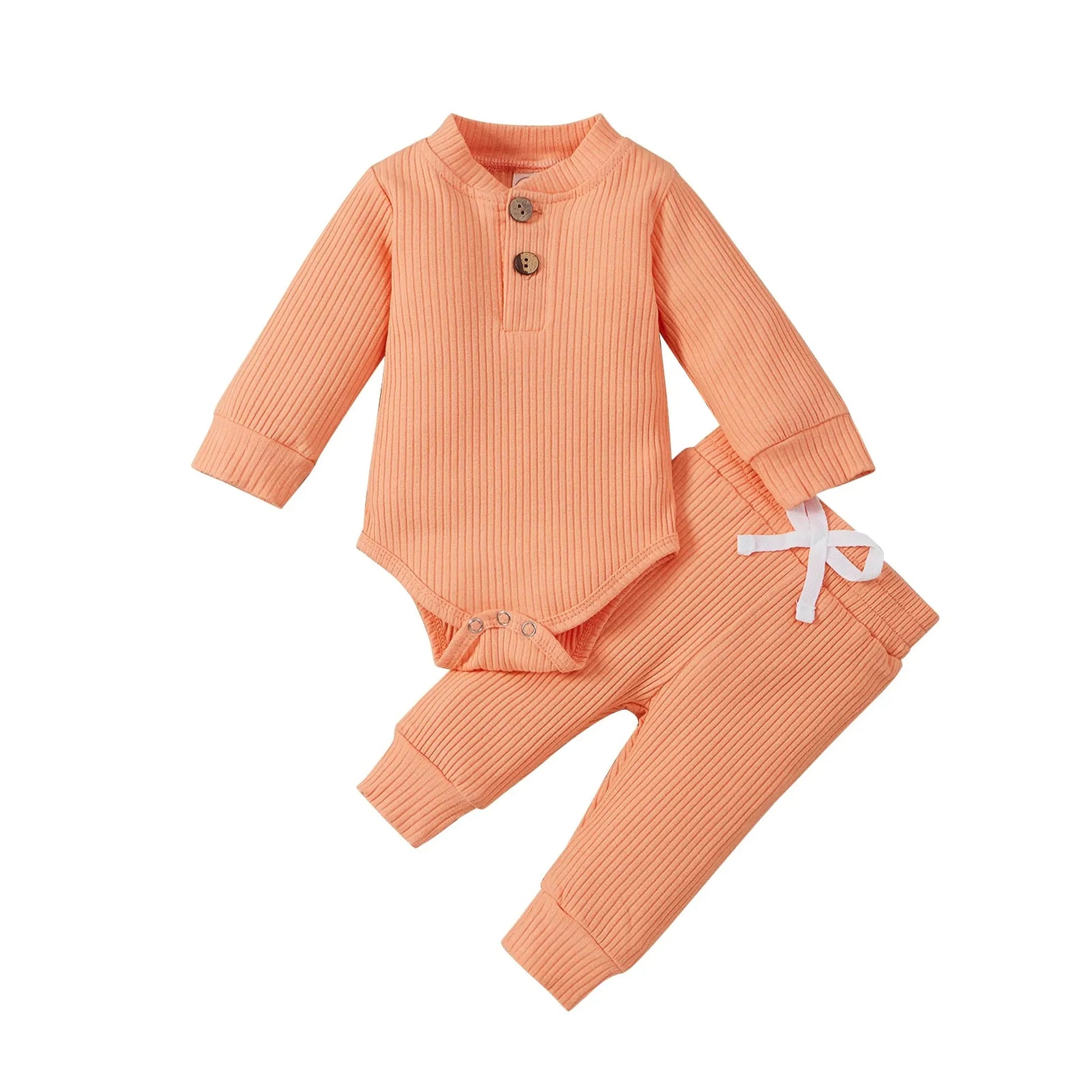 Peach ribbed cotton long-sleeve baby bodysuit and matching pants with white drawstring.