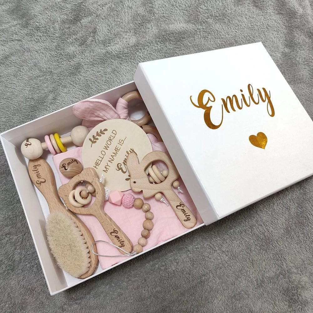 Personalized 8-piece natural wood baby gift set with rattles, brush, and pacifier clip in a white box.
