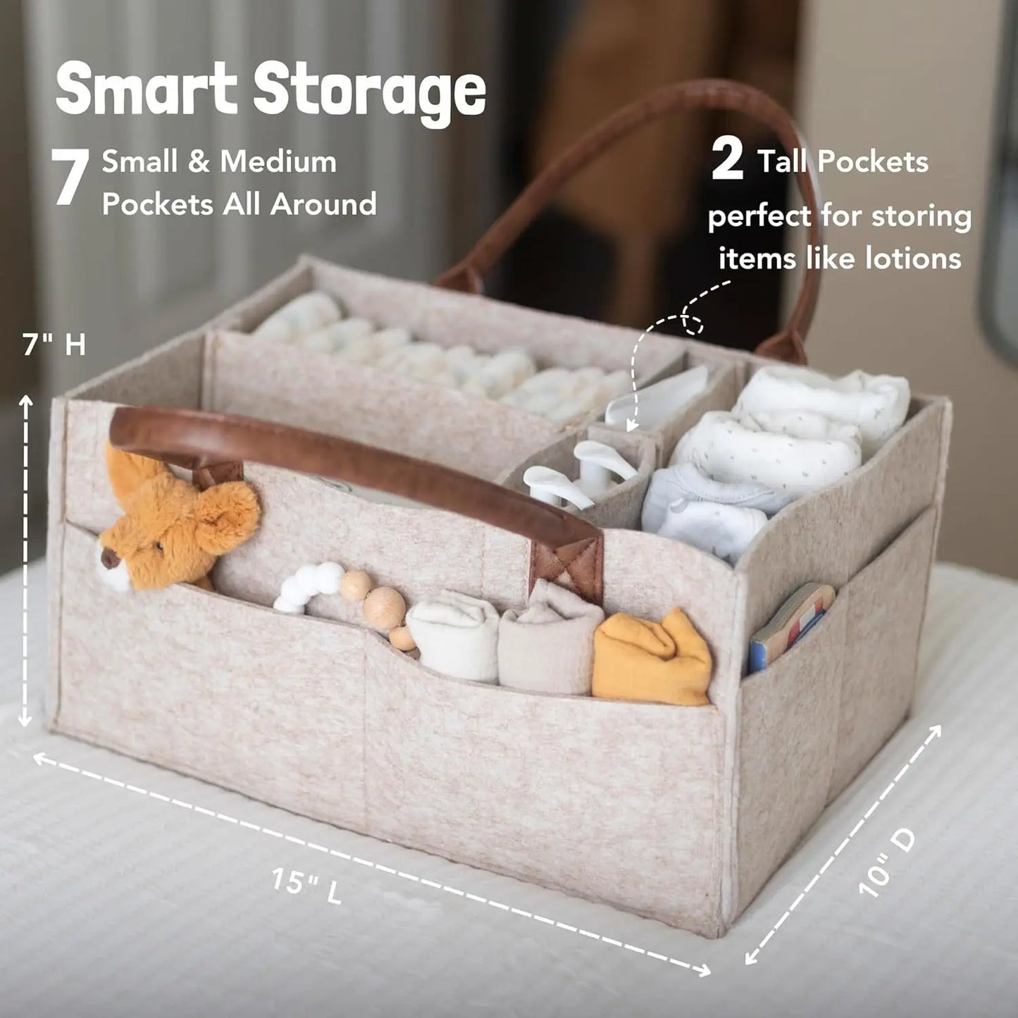 Beige felt diaper caddy with brown leather handles, multiple compartments, and side pockets for baby essentials.