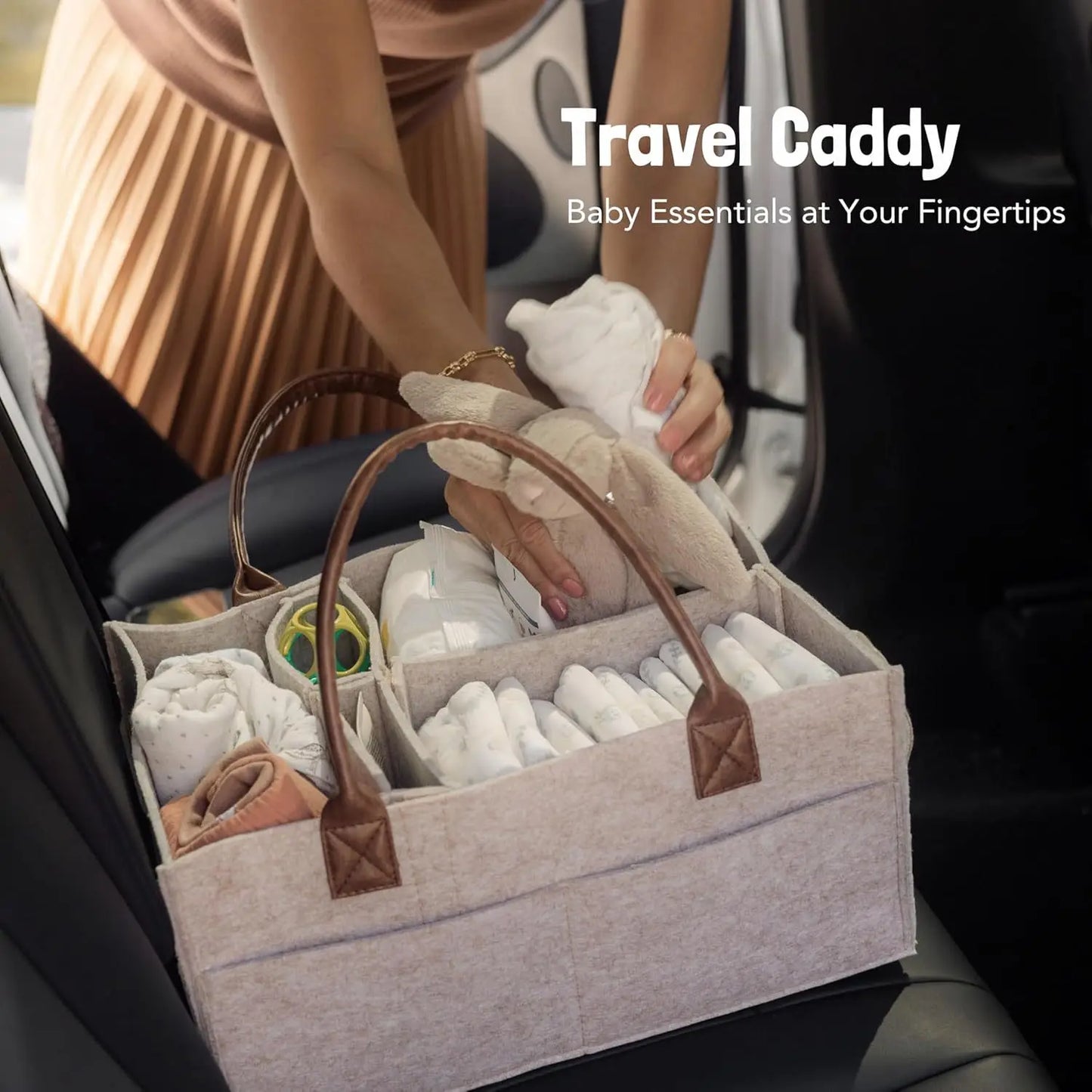 Beige felt baby diaper caddy with brown faux leather handles, filled with baby essentials in a car.