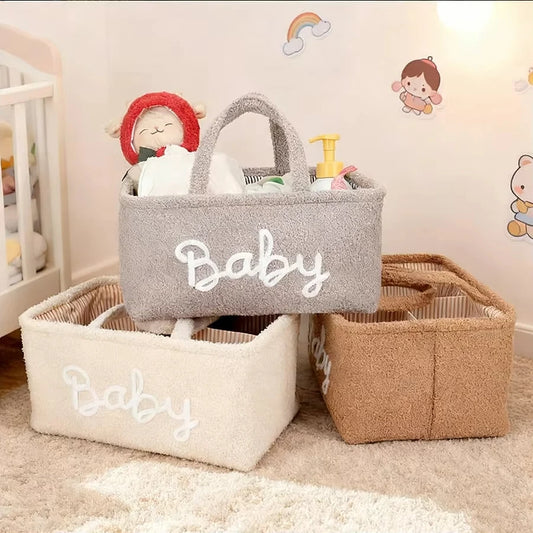 Soft fleece baby diaper caddy in gray, cream, and brown, with "Baby" embroidered, handles, and organized compartments.