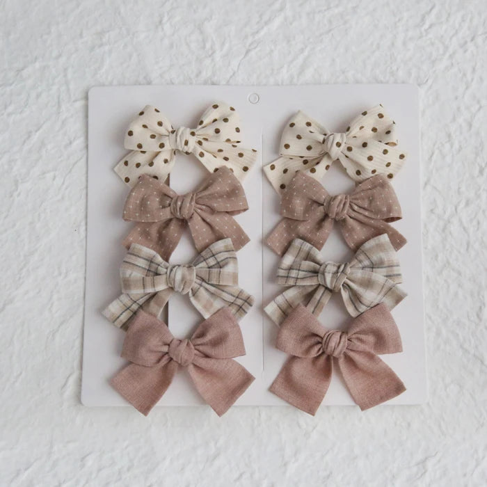 Set of 8 girls' cotton hair bows in various neutral colors and patterns, including polka dots and plaid.