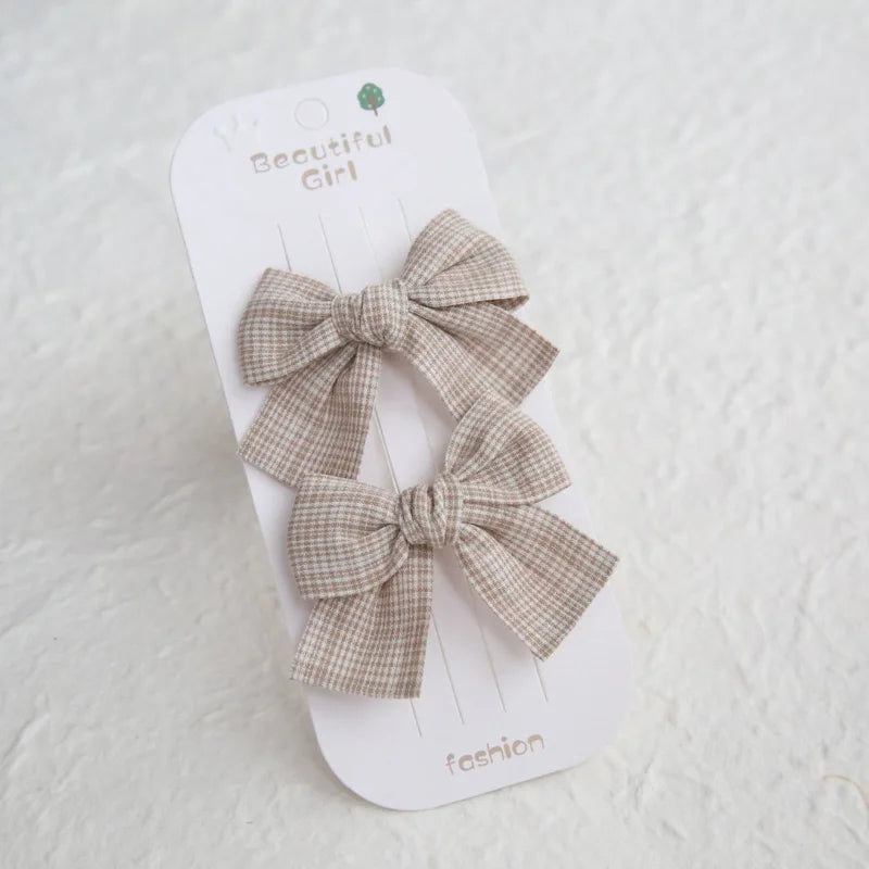 Two beige plaid cotton hair bows on a white "Beautiful Girl" card, 7.5cm bows, 4cm clips.