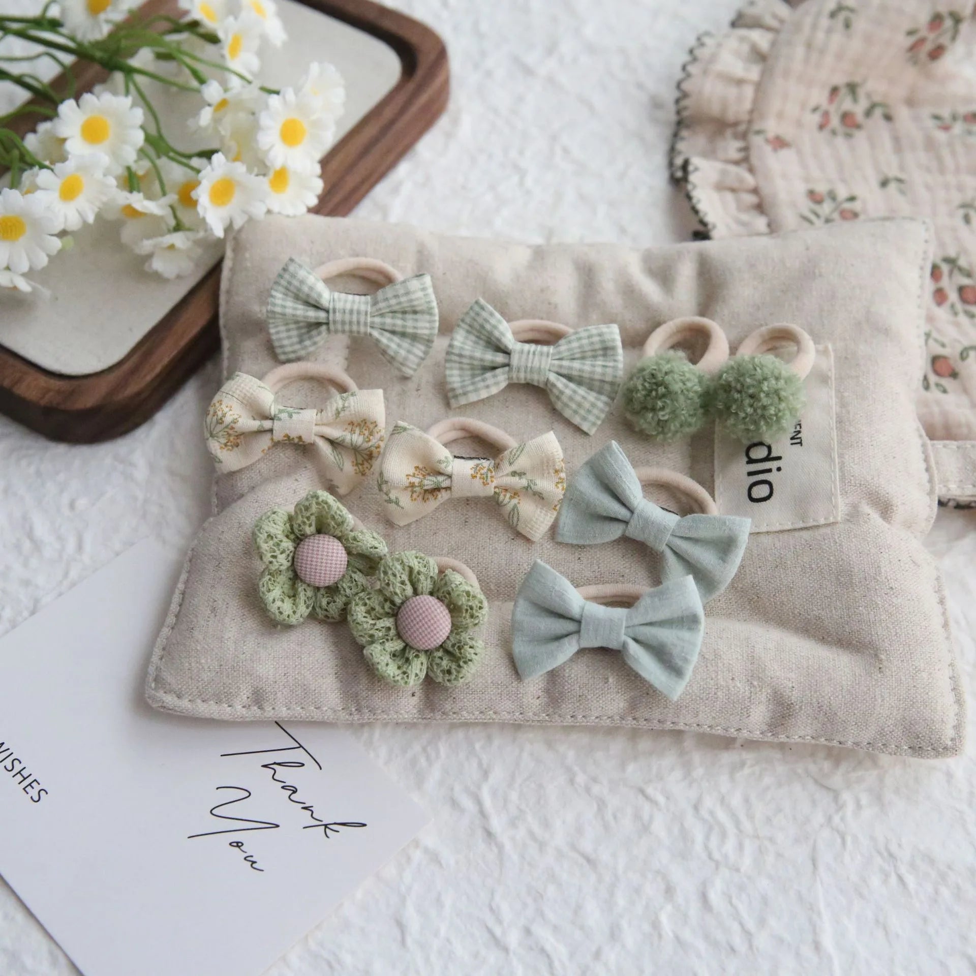10-piece set of girls' cotton hair ties and clips in green, floral, and plaid designs.