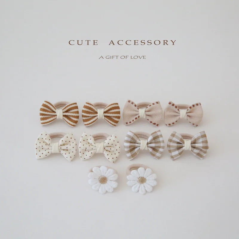 10-pack of girls' cotton hair ties and clips: beige, brown, striped, polka dot, plaid bows, and white flower designs.