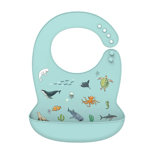 Adjustable light blue silicone baby bib with ocean animal print and deep catch-all pocket.