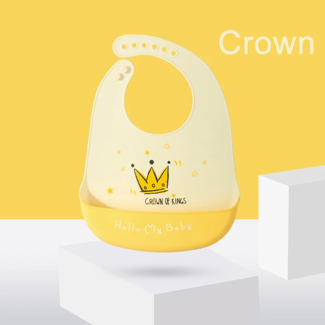 Yellow silicone baby bib with a crown design and adjustable neck strap.
