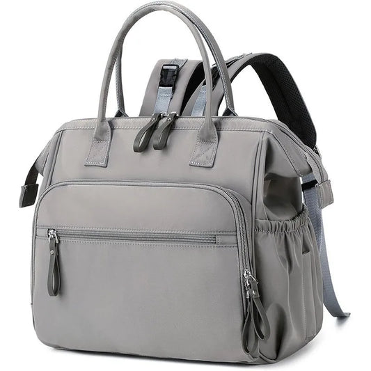 Gray polyester diaper backpack with top handles, front zip pockets, and side pockets.