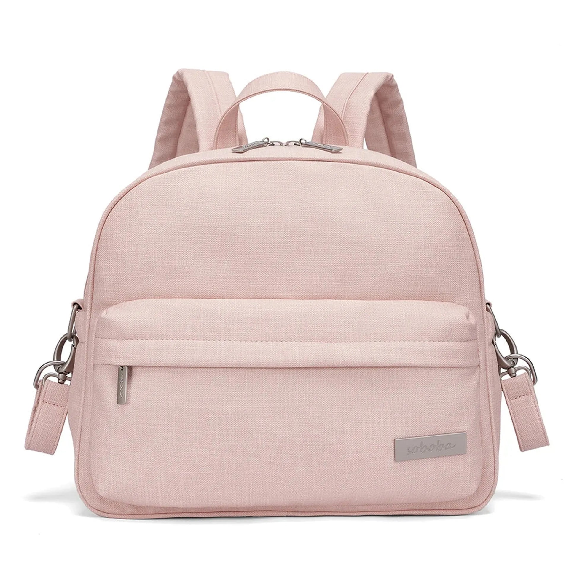 Stylish pink diaper backpack with front pocket, adjustable straps, and silver hardware.