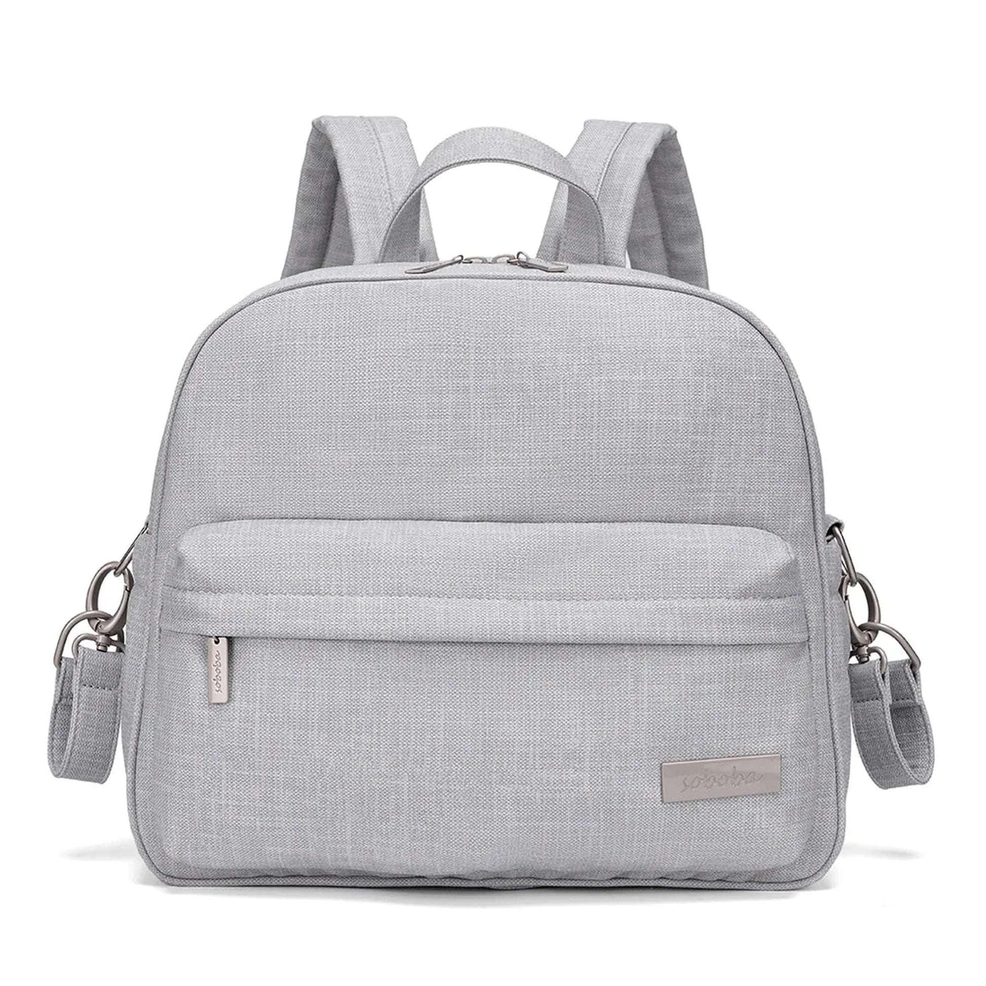 Stylish light gray diaper backpack with front pocket, top handle, and adjustable shoulder straps.