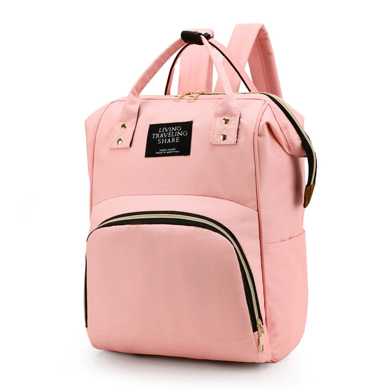 Pink canvas diaper backpack with thermal pocket and black zippers.