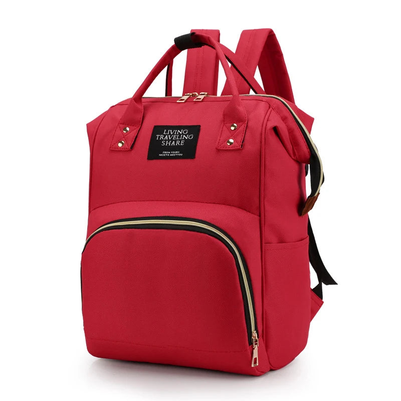 Red canvas diaper backpack with thermal pocket, front zipper, and top handles.