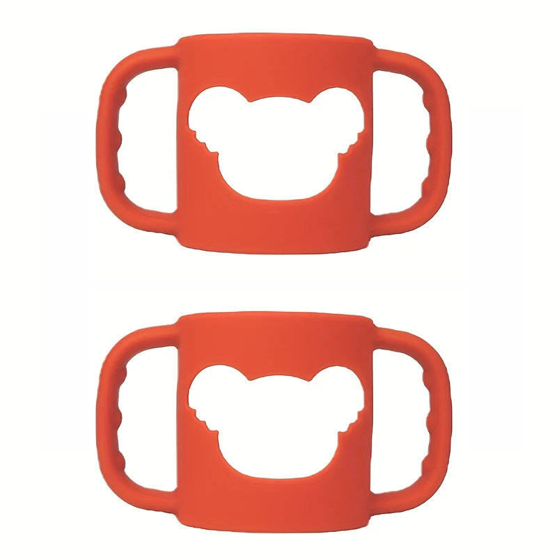 Two orange silicone baby bottle handles with a bear-shaped cutout, designed for easy grip.